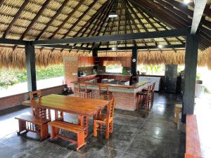 a kitchen with a wooden table and chairs in a pavilion at finca playa alta in Palmira