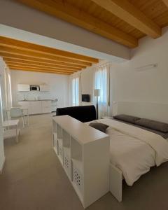 una camera bianca con letto e soggiorno di Residence Duomo a Castelfranco Veneto