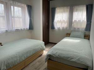 En eller flere senge i et værelse på Enoshima HOME2 - Vacation STAY 20227v