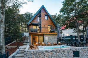 a house with a pool in front of it at The Magic Forest - Holiday Home & Spa Zone Platak in Soboli