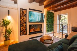 a living room with a couch and a fireplace at The Magic Forest - Holiday Home & Spa Zone Platak in Soboli