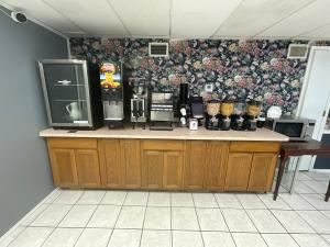 a kitchen with a counter top with a coffee maker at SUNSET INN in Branson