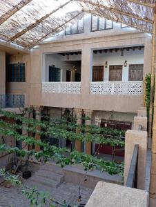 a building with a bunch of plants on the side of it at Hyba Pod Hostel & Hotel in Dubai