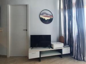 a living room with a television on a white cabinet at Apartment Los Cristianos in Los Cristianos