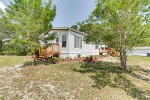 una casa con terraza y un patio con árboles en Weeki Wachee Vacation Rental about 13 Mi to the Ocean!, en Spring Hill