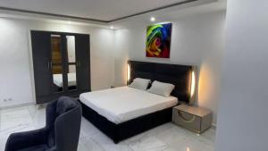 1 dormitorio con 1 cama y 1 silla en BI HOTEL 2 en Dakar