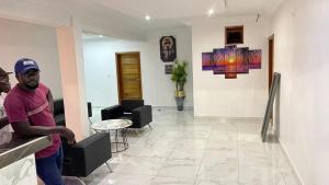 a man standing at a counter in a room at BI HOTEL 2 in Dakar