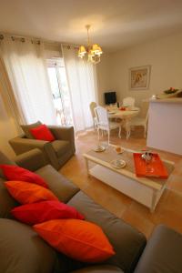 uma sala de estar com um sofá e uma mesa em Lagrange Vacances Les Bastides des Chaumettes em Montauroux