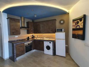 a kitchen with a washer and dryer in it at Apartment Los Cristianos in Los Cristianos