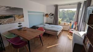 a bedroom with a bed and a table and chairs at Seemöve in Glücksburg