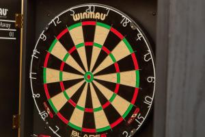 a dart board with the words winawi on it at Large 4-Bed Home with Free Parking Perfect for Big Groups in Litherland