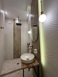 a bathroom with a sink and a mirror at Сity center Loft style Apartment in Tbilisi City