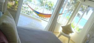 a bedroom with a bed and a view of the ocean at WorldClass Kitebeach Cabarete in Cabarete