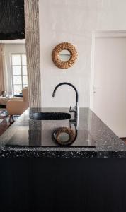 a kitchen counter with a sink and a mirror at Villa Mavro Mavrovo in Mavrovo