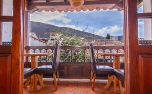Elle comprend un balcon avec deux chaises et une grande fenêtre. dans l'établissement Bello Hogar Hospedaría VDL, à Villa de Leyva
