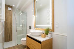a bathroom with a sink and a toilet and a shower at Apartament Magiczne Podhale by Apart Concept Podhale in Kościelisko +36 photos