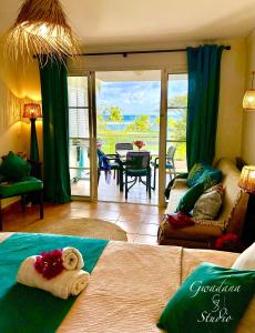 a bedroom with a teddy bear laying on a bed at Accès Direct Plage, Magnifique Vue Mer, Les Gwada Studios, Village Vacances in Sainte-Anne