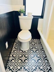 a bathroom with a toilet and a tile floor at The perfect Little Cottage for your gateway! in Umatilla +20 photos
