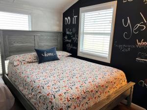 a bedroom with a bed with a comforter on it at The perfect Little Cottage for your gateway! in Umatilla
