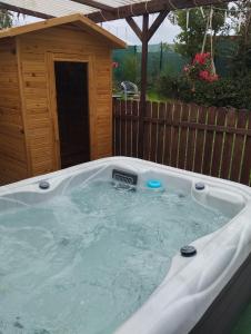 a hot tub in a backyard with a dog house at Welness, Holiday Cheb-Skalka in Cheb