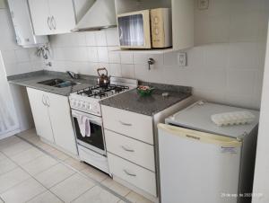 a small kitchen with a stove and a sink at Marconi in Venado Tuerto