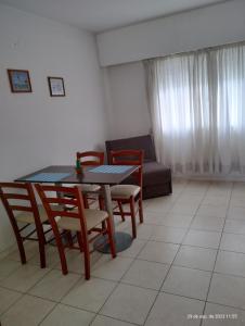a living room with a table and chairs and a couch at Marconi in Venado Tuerto