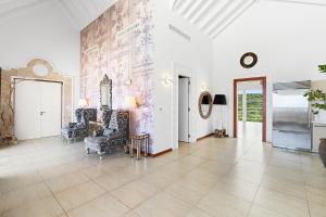 a living room with white walls and a tile floor at The Manoah Boutique Hotel in Shoal Bay Village