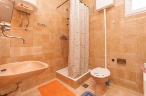 La salle de bains est pourvue d'une douche, de toilettes et d'un lavabo. dans l'établissement Apartments Jasminka, à Poljica