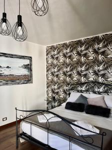 a bedroom with a bed with a wall at Tyche House Castelmola in Castelmola