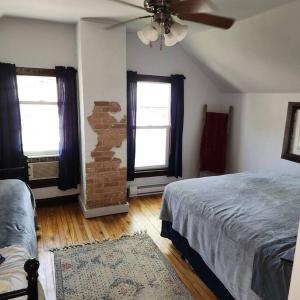 a bedroom with two beds and a ceiling fan at Cottage on Shawano Lake. On The Beach in Shawano