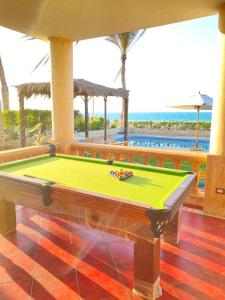 a pool table in a room with a beach at فيلا اول صف بحر مارينا الساحل الشمالي العلمين برايفت بول in El Alamein