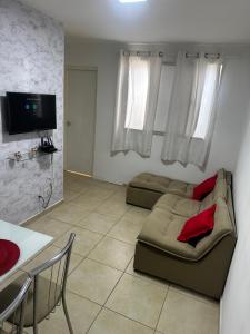 a living room with a couch and a tv at Apt da Leily in São Luís