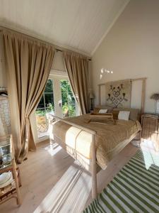 a bedroom with a large bed and a large window at Villa Tilda in Matildedal