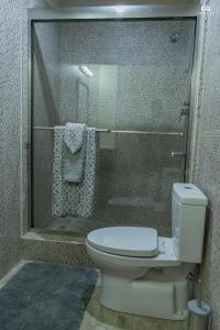a bathroom with a toilet and a shower at SkylineSuites Lost in Paradise - FA4 in Grand Anse