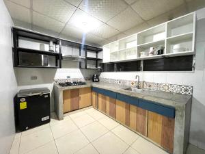 a kitchen with a sink and a counter top at OyeBonita Hostel in Panama City