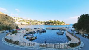 a marina with boats in the water next to a road at Green Moonlight in Ulcinj