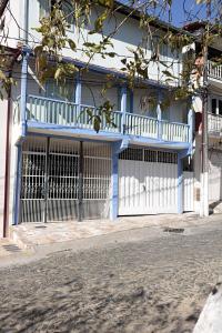 ein blau-weißes Gebäude mit einem Tor in der Unterkunft Ouro Preto Suítes in Ouro Preto