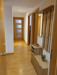 a hallway with a bathroom with a sink and a mirror at Apartamentos Canana de Vega in Flix