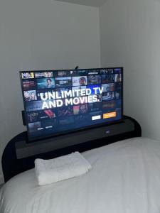 a flat screen tv sitting on top of a bed at Capewell Gibson House in Rotherham