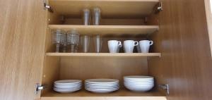 a cupboard with plates and vases and bowls at Ferienhaus Sommer mit Klimaanlage in Neckarsulm