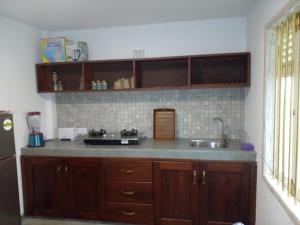 a kitchen with a sink and a counter top at COCO RELAX AYURVEDA VILLAS in Hikkaduwa