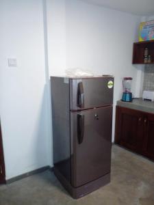 a stainless steel refrigerator in a kitchen at COCO RELAX AYURVEDA VILLAS in Hikkaduwa