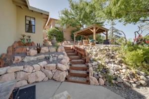 a stone retaining wall with stairs in front of a house at Tuscan Getaway with Premier Vineyard Views! in Cottonwood