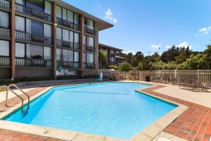 a swimming pool in front of a building at Red Lion Hotel Monterey in Monterey