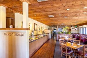 a restaurant with wooden ceilings and wooden tables and chairs at Red Lion Hotel Monterey in Monterey