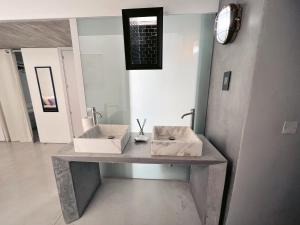 a bathroom with two sinks and a mirror at STUNNING AND SPACIOUS - 1BR PENTHOUSE in Valletta +20 photos