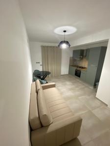 uma sala de estar com um sofá e uma cozinha em Casa vacanza Scala dei Turchi em Realmonte