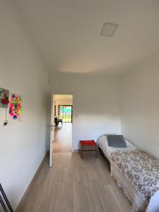 a bedroom with two beds and a hallway at SUKHA in Baradero +25 photos