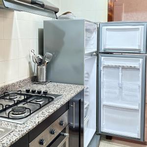 a kitchen with a stove and a refrigerator at Best Apartment in Marina Agadir in Agadir