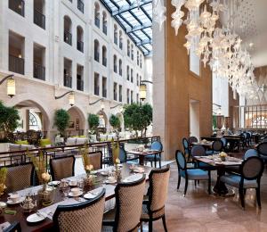 a dining room with tables and chairs in a building at Waldorf Astoria Jerusalem in Jerusalem